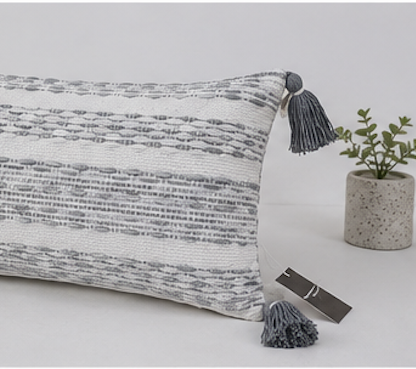 Add a touch of elegance and comfort to your living space with this beautifully handwoven cotton cushion cover. Featuring a sophisticated grey and ivory textured pattern with decorative tassels